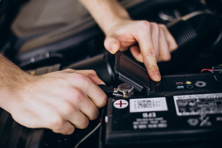 Mechanic testing battery voltage output