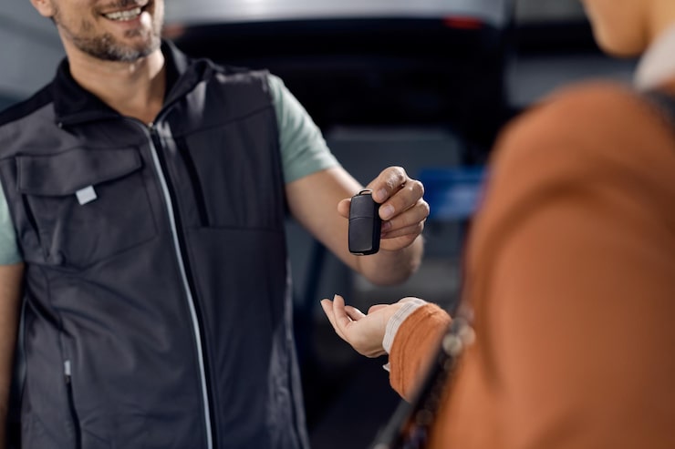 Mechanic handing over car keys