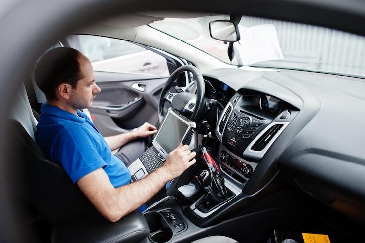 Computer diagnostic scanner on dashboard