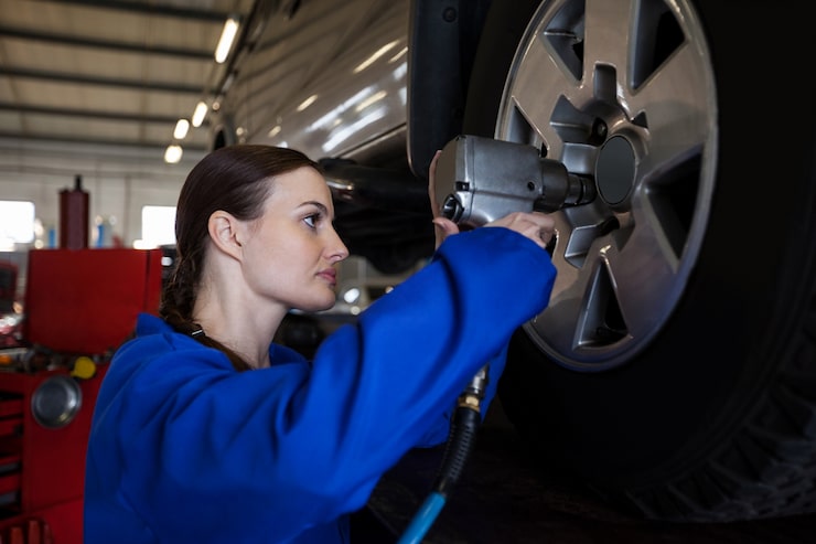 Mechanic adjusting wheel alignment