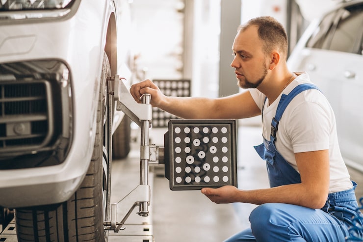 Mechanic measuring tyre tread blocks
