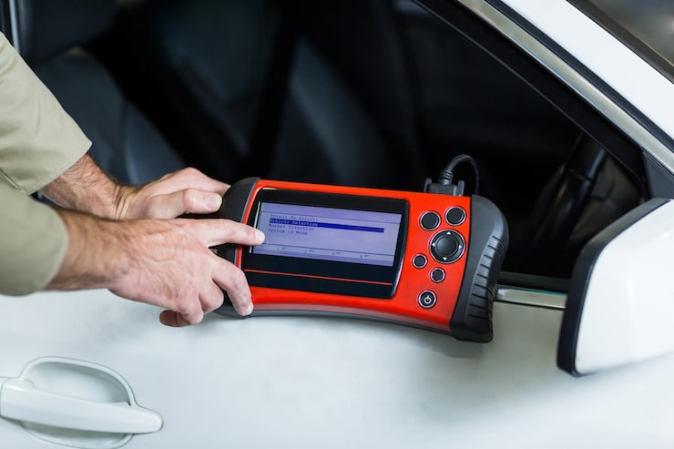 Diagnostic scan tool connected to OBD port